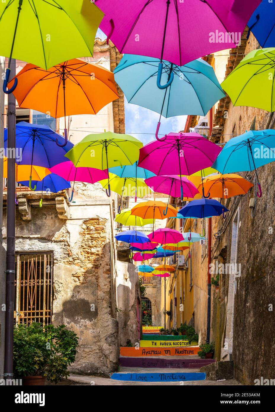Typical narrow street with colorful floating umbrellas in Nicotera, Calabria, Italy Stock Photo