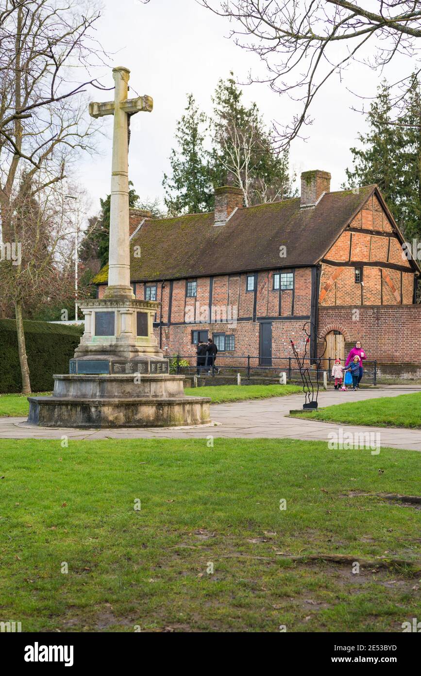 Ruislip war memorial with the Tudor period alms houses in background. Ruislip, Middlesex, England, UK Stock Photo