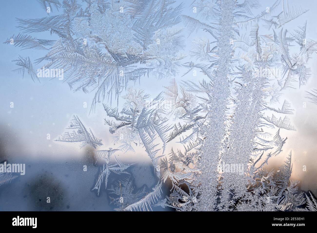 Early morning. Heating season. Ice flower on a frozen window. Stock Photo