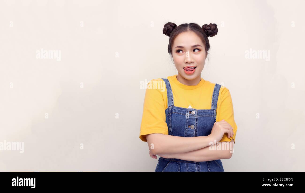 Close up portrait of hipster lovely, cute, sweet, gorgeous, nice lady in casual wear isolated on shine white background lovely show tongue Stock Photo
