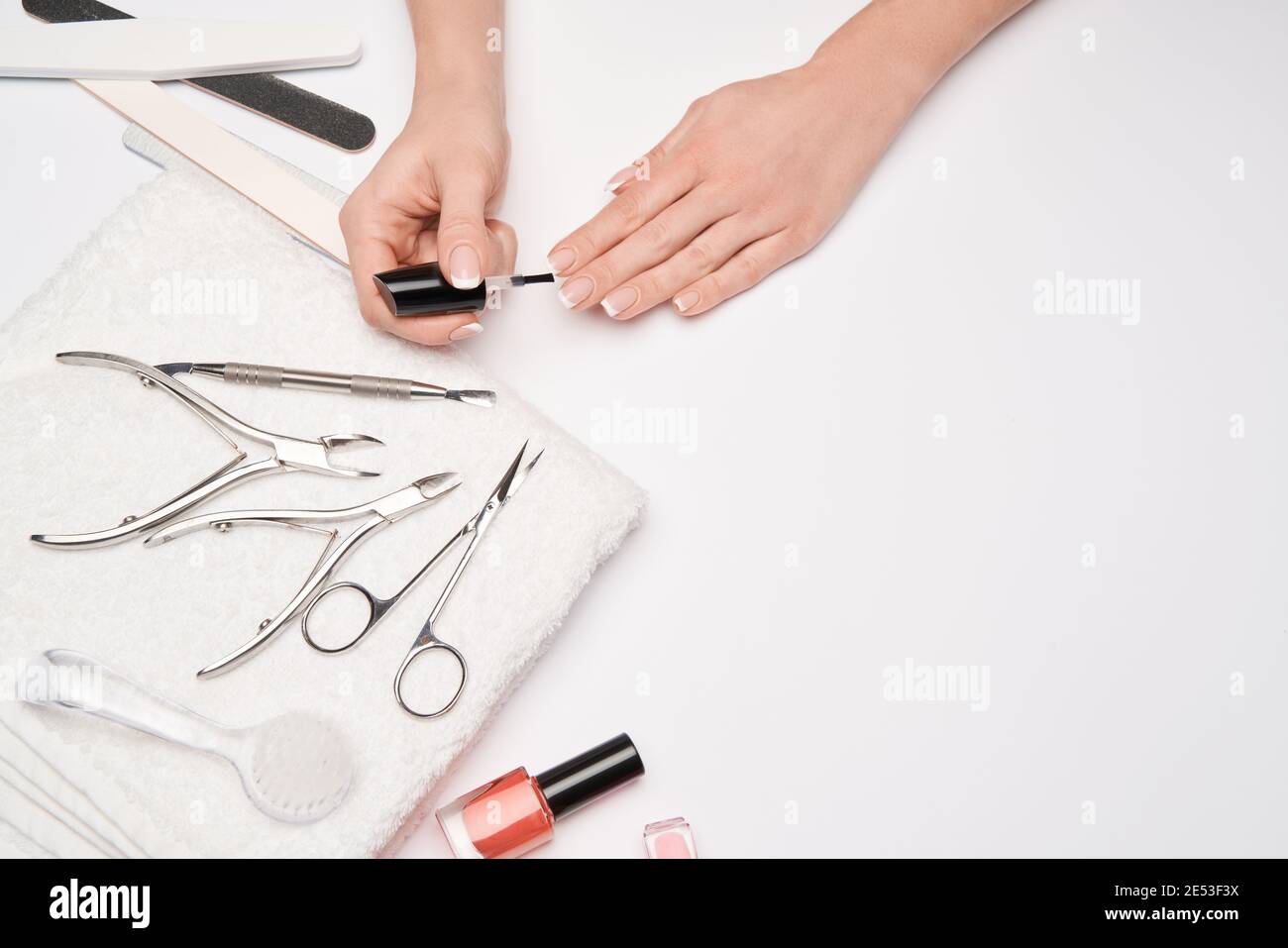 top view of manicure tools set for nail care over light background - brush, scissors, nail polish, file and tweezers Stock Photo