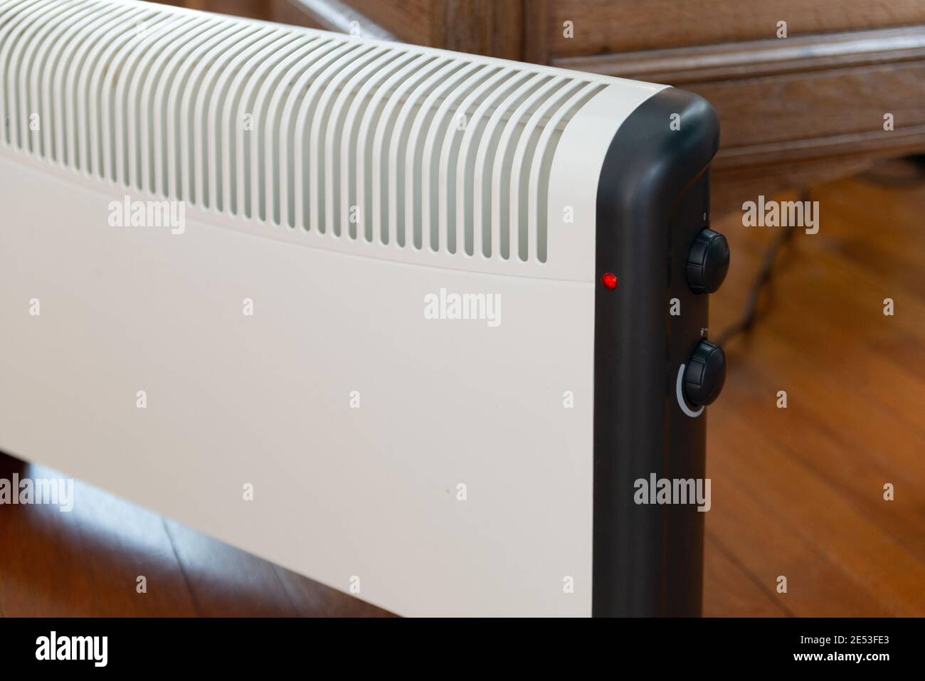 Close-up of an electric heater on parquet floor at home Stock Photo