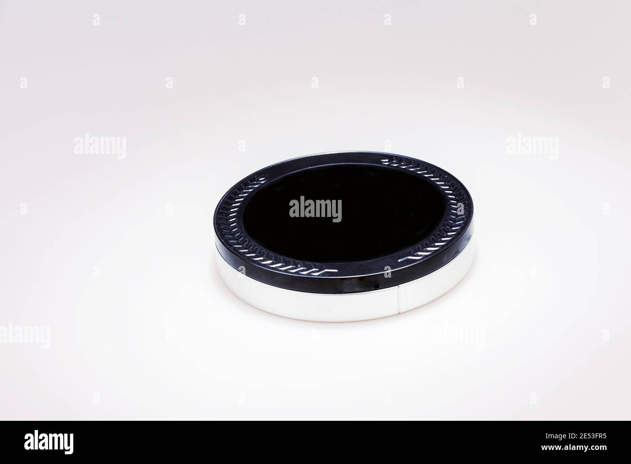 Flat metal box with black lid and silver bottom isolated on white. Stock Photo