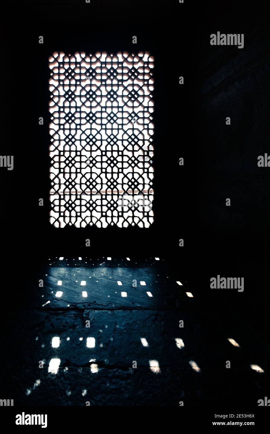 Light shining through stone window grill; India Stock Photo