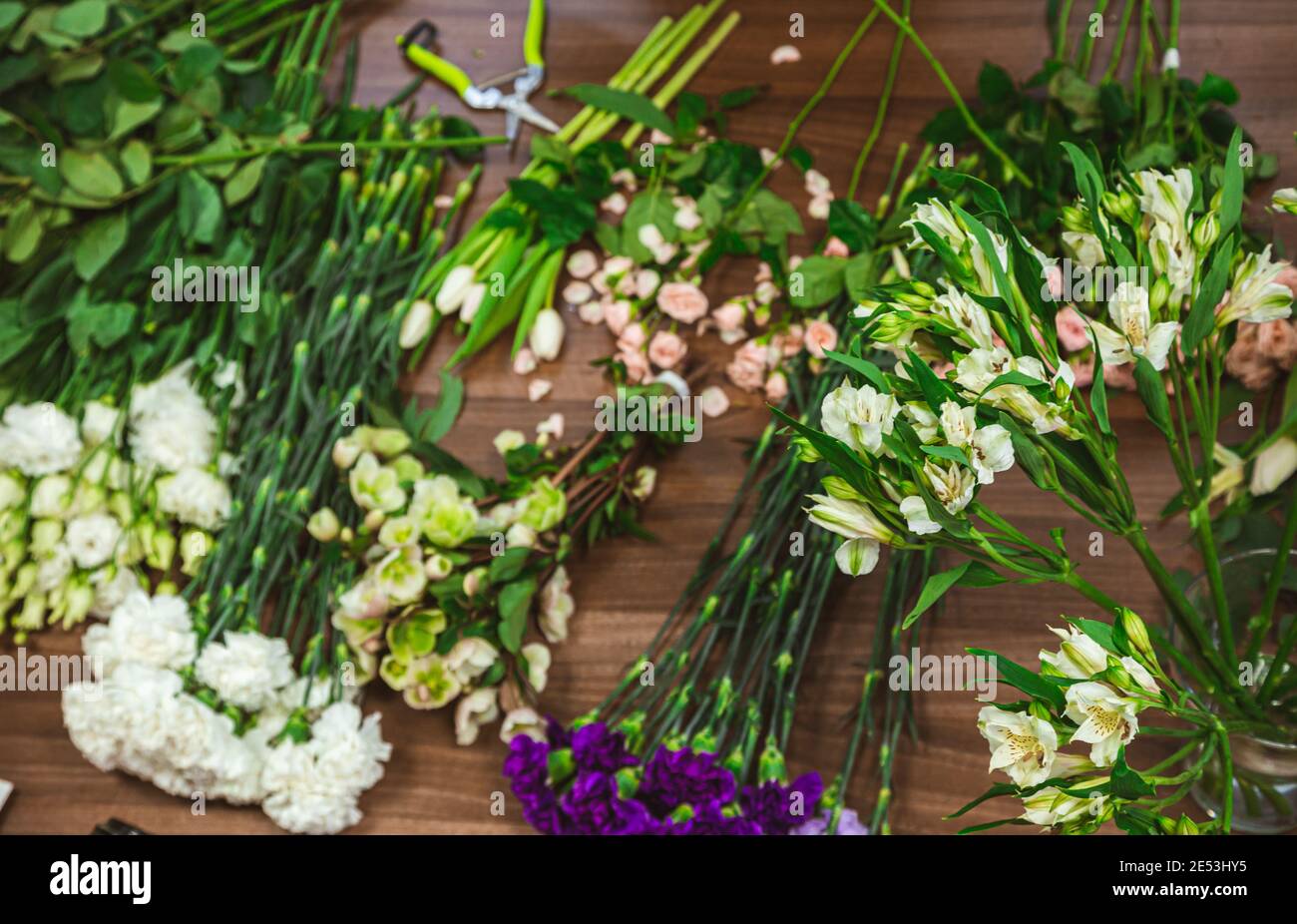 Attractive young woman florist is working in a flower shop Stock Photo ...