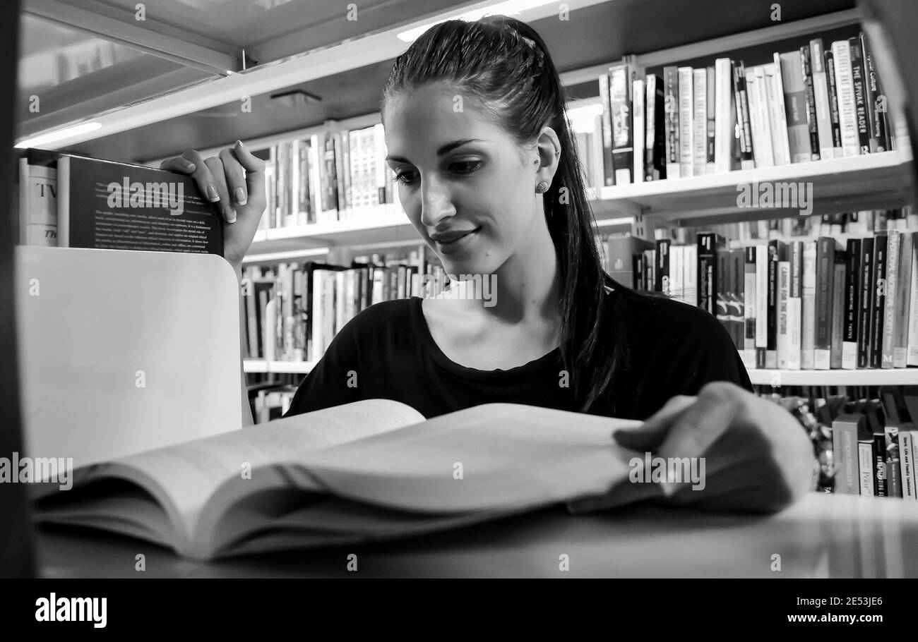 JOHANNESBURG, SOUTH AFRICA - Jan 05, 2021: Johannesburg, South Africa, April 17, 2012, Female student reading in College Campus Library Stock Photo