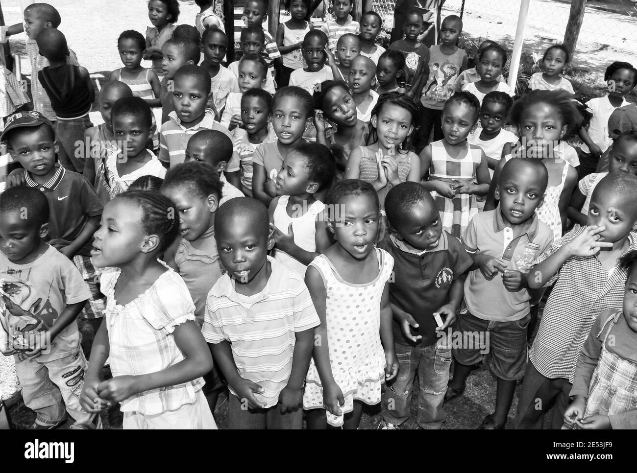 JOHANNESBURG, SOUTH AFRICA - Jan 05, 2021: Soweto, South Africa - November 16, 2012: Young African Preschool kids singing songs in the playground of a Stock Photo