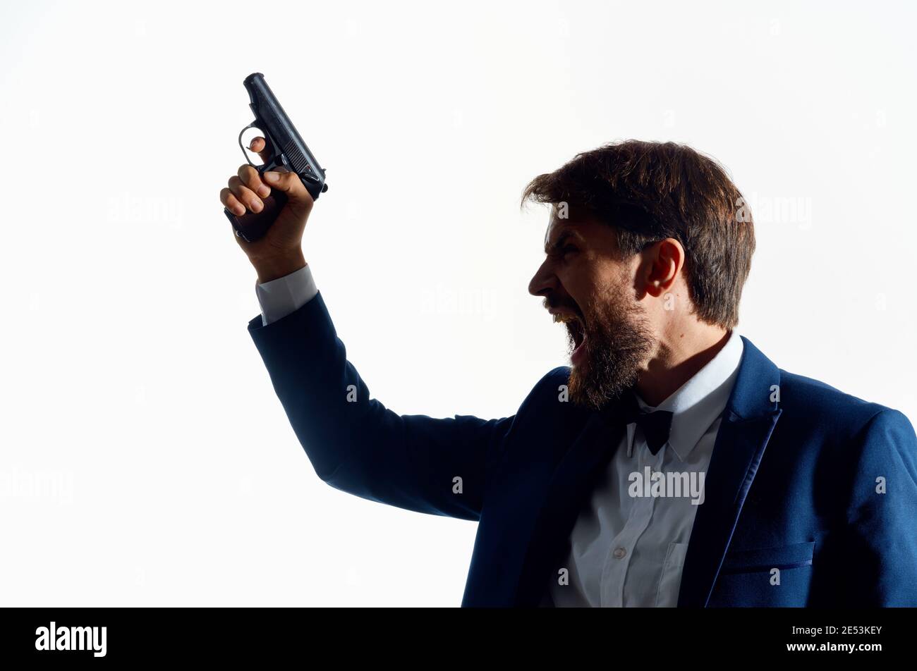 man in suit holding pistol lost his head suicide isolated background Stock Photo