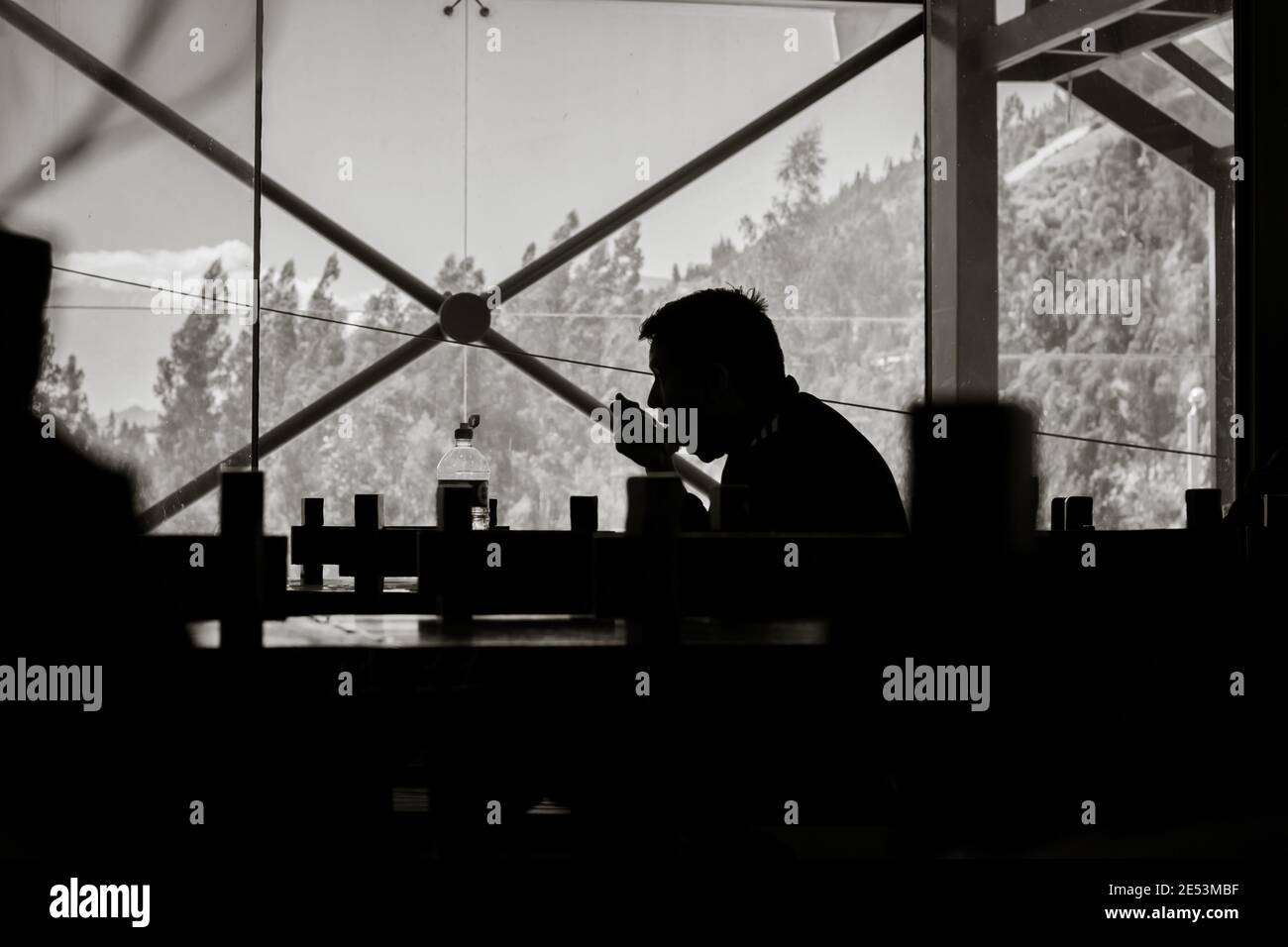 HUARAZ, PERU - Jul 15, 2018: Horizontal shot of the silhouette of a man having lunch in restaurant Stock Photo
