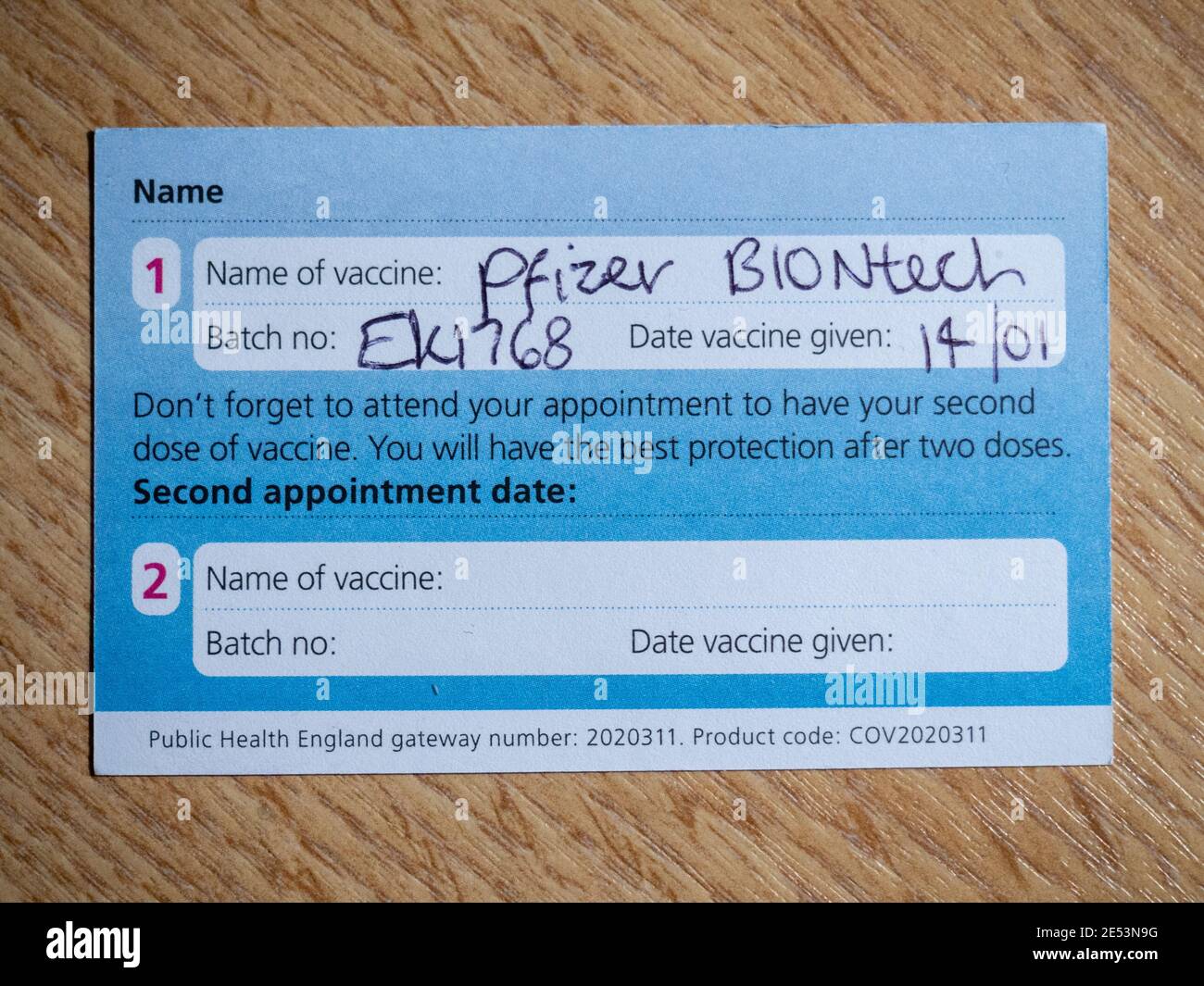 Reverse of an NHS Covid-19 vaccination record card indicating that the individual has received the first dose of Pfizer Biontech vaccine. Stock Photo