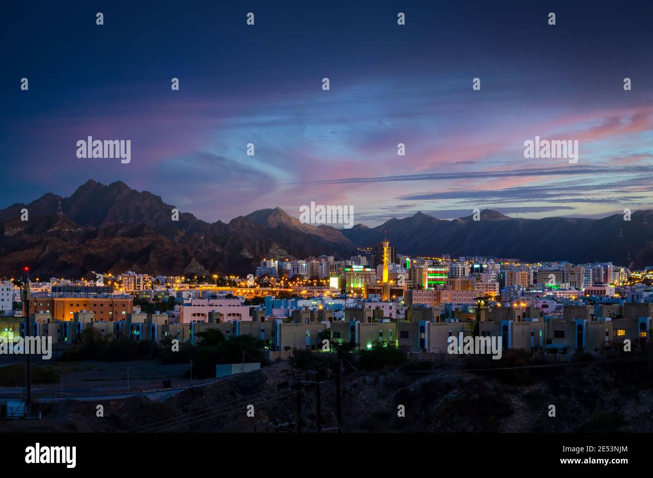 Illuminated buildings during an evening in Muscat, Oman with beautiful sky in the background Stock Photo