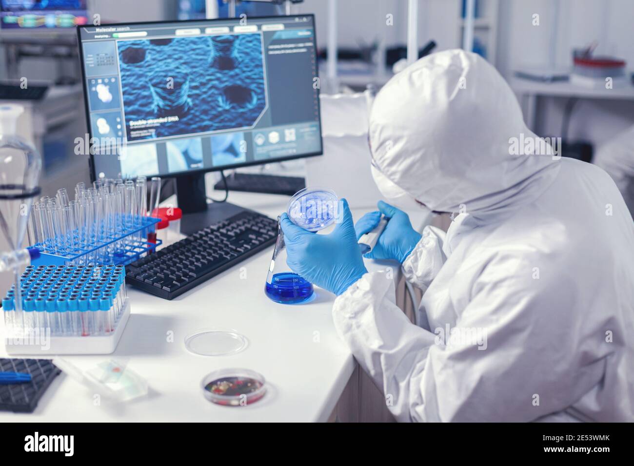 Doctor In Medicine Lab Engineering Virus On Petri Dish Dressed In Coverall Chemist In Modern Laboratory Doing Research Using Dispenser During Global Epidemic With Covid 19 Stock Photo Alamy