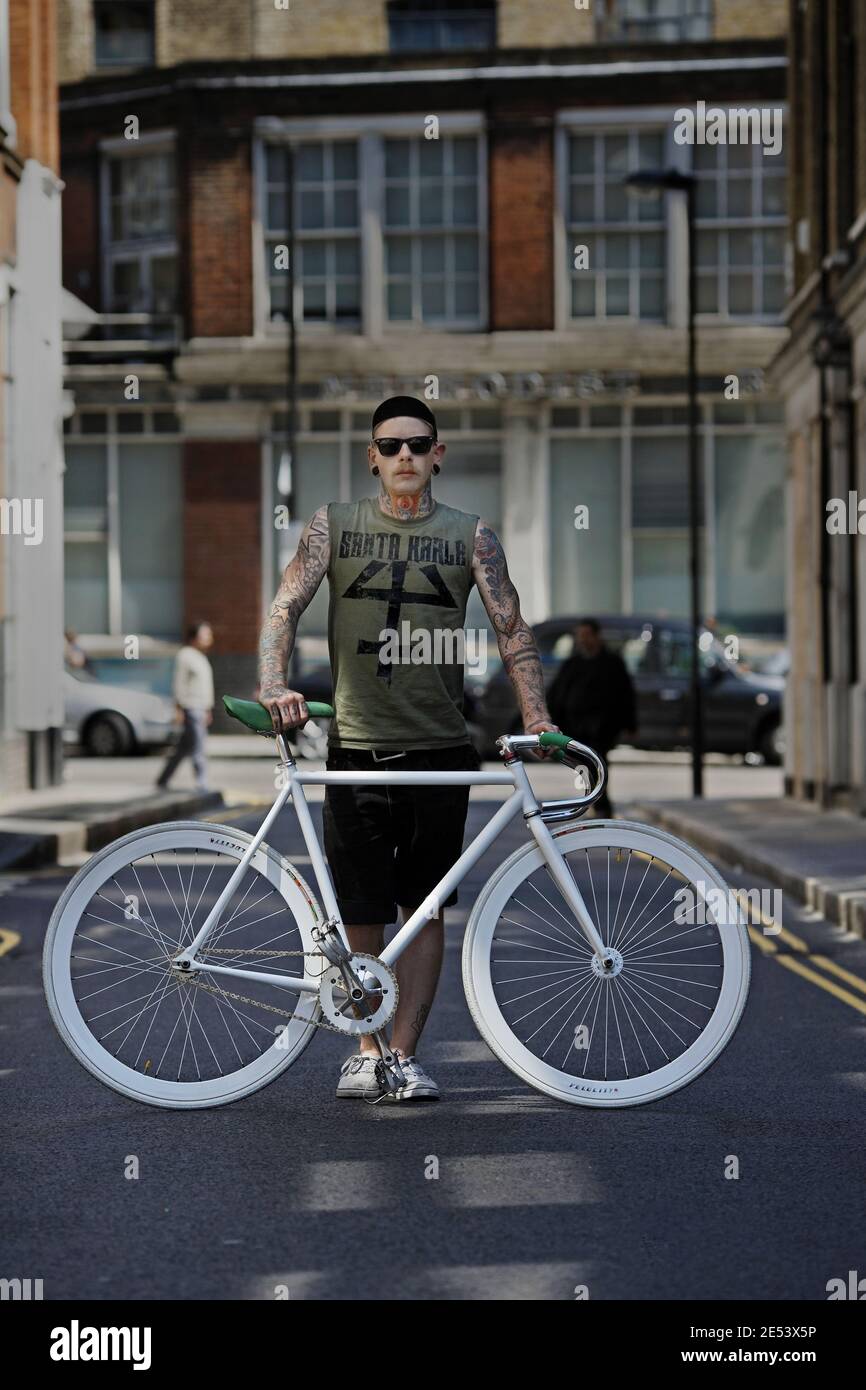 young hipster man riding fixed gear bike , London , UK Stock Photo