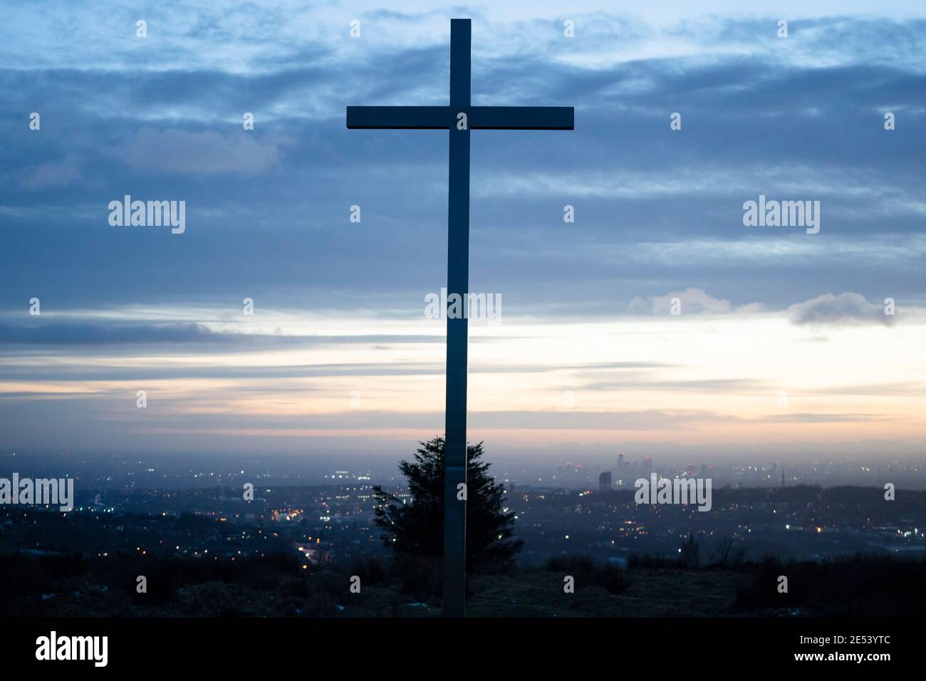 Manchester, UK, 25th Jan 2021. A cross erected by local residents to mark the millennium stands is the the hills above Oldham near Manchester as the country approaches 100,000 Covid-19 deaths in the face of the Coronavirus, Manchester, UK. Credit: Jon Super/Alamy Live News. Stock Photo