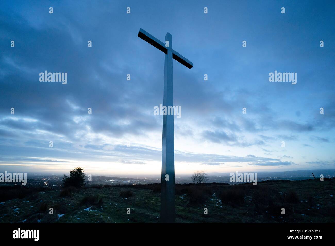 Manchester, UK, 25th Jan 2021. A cross erected by local residents to mark the millennium stands is the the hills above Oldham near Manchester as the country approaches 100,000 Covid-19 deaths in the face of the Coronavirus, Manchester, UK. Credit: Jon Super/Alamy Live News. Stock Photo
