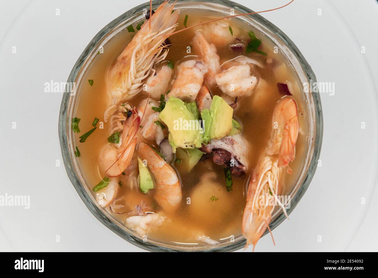 Overhead view of bowl of warm shrimp broth with head and tail included in soup. Stock Photo