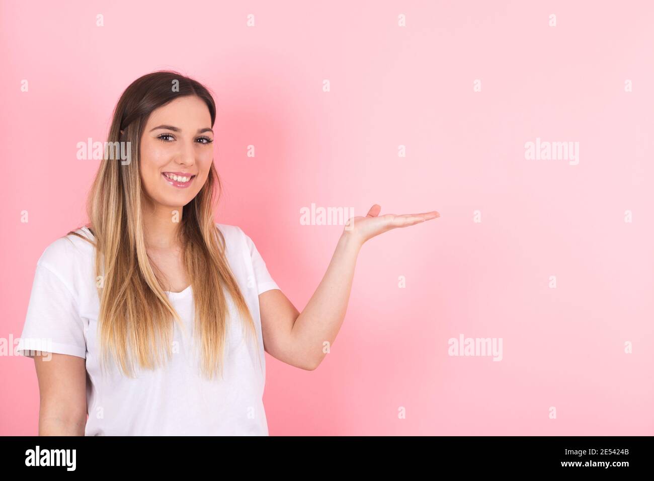 young woman shows space to the side. Image for marketing and advertising Stock Photo