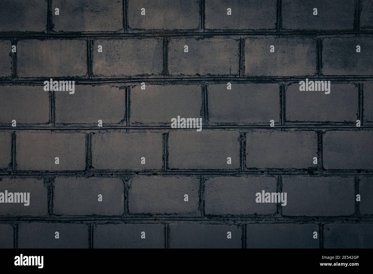 Dark grey brick wall. Abstract decorative grey background or art