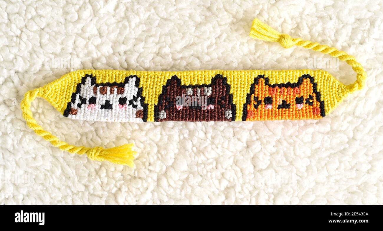 Woven DIY friendship bracelet with Cats pattern handmade of embroidery  floss Stock Photo - Alamy