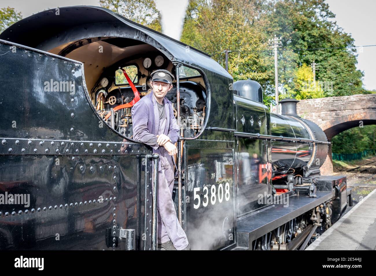 The driver of BR '7F' 2-8-0 No. 53808 waits for the 'right-away' at Bishops Lydeard station on the West Somerset Railway Stock Photo