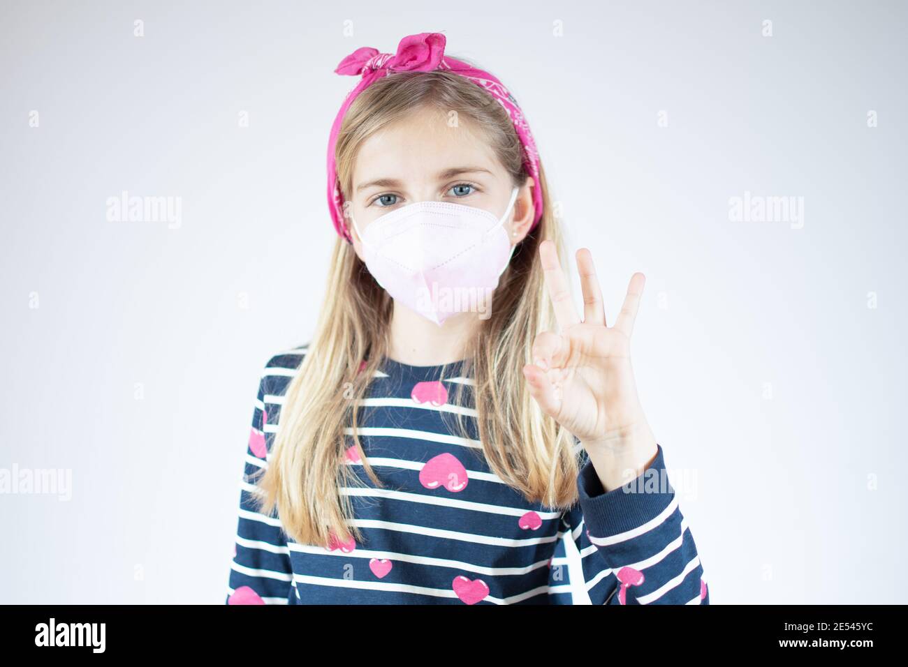 Infection concept. Portrait of little girl wearing medical mask over ...