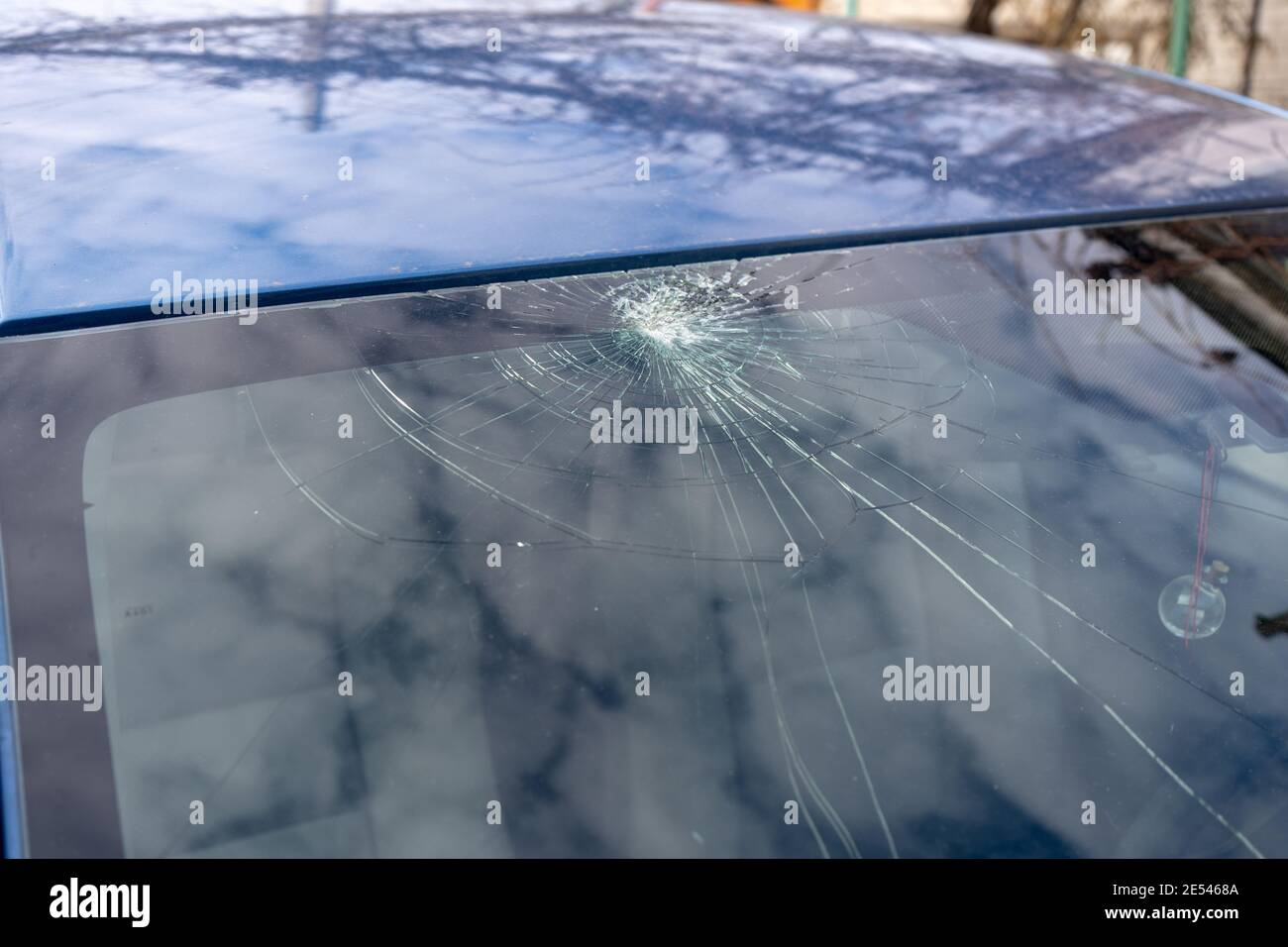 broken windshield with a lot of cracks and small glass pieces, damaged