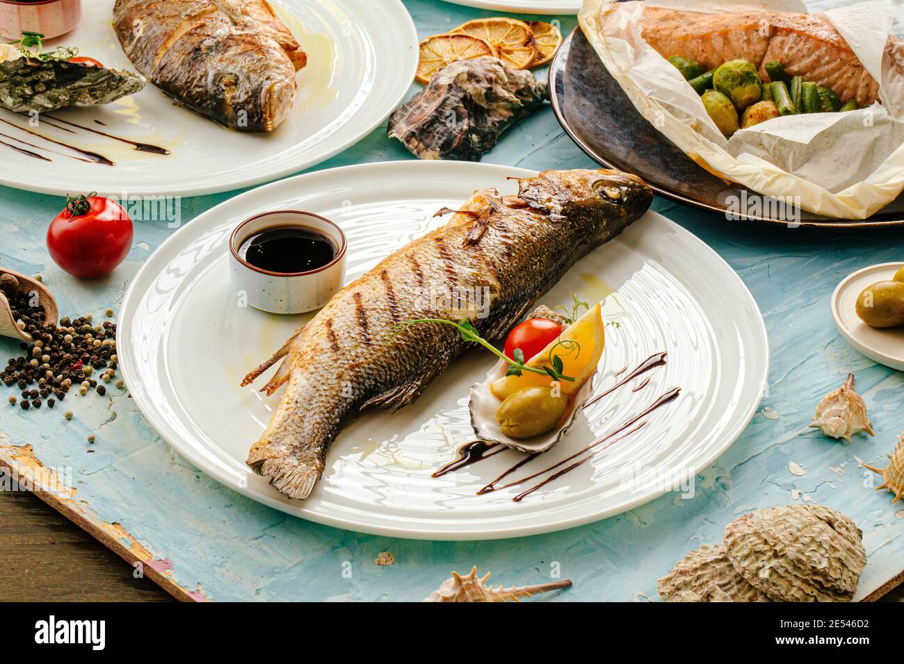 Gourmet grilled sea bass fish on the served table Stock Photo