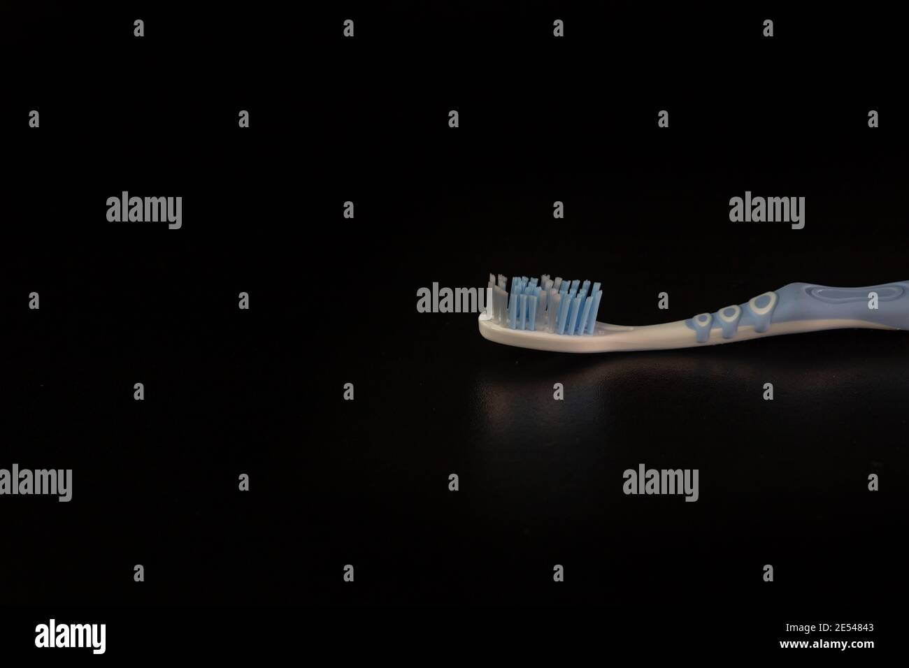 Selective focus on toothbrush isolated on black background. Stock Photo