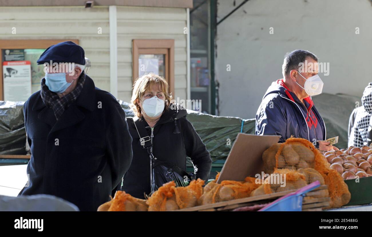 People with safety masks shopping food during coronavirus ( COVID-19 ) outbreak on a market in Sofia, Bulgaria on 01/24/2021 Stock Photo