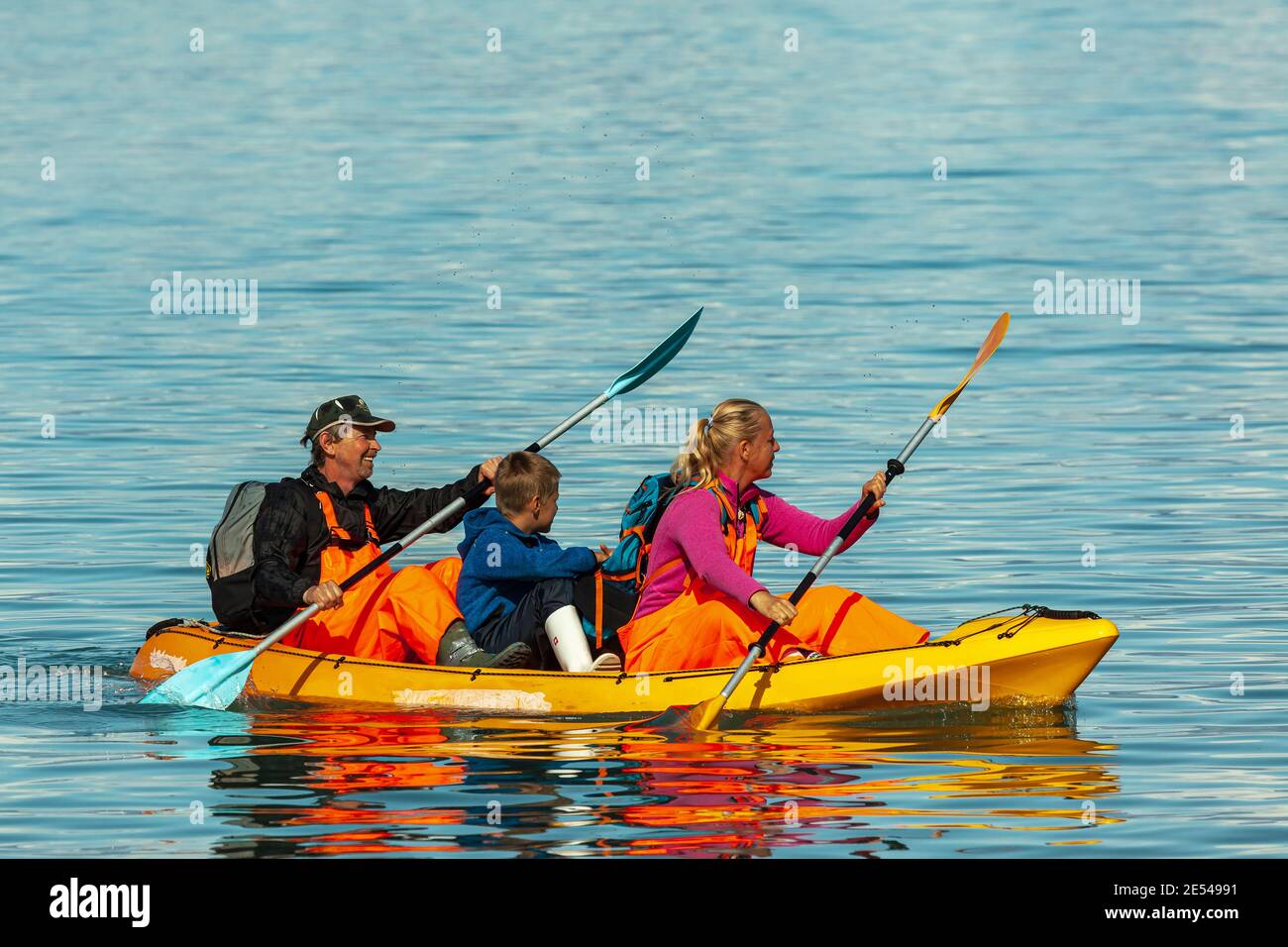 Two adults and a child on a kayak in Pond Inlet (North West Passage, Canada) Stock Photo