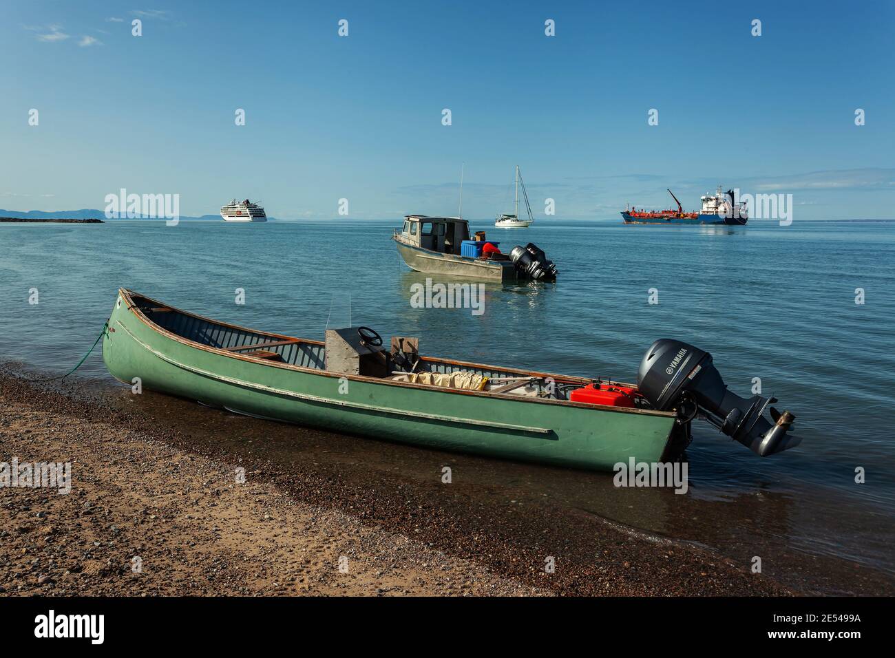 Green Inuit canoe with an engine by the beach in Pond Inlet Stock Photo