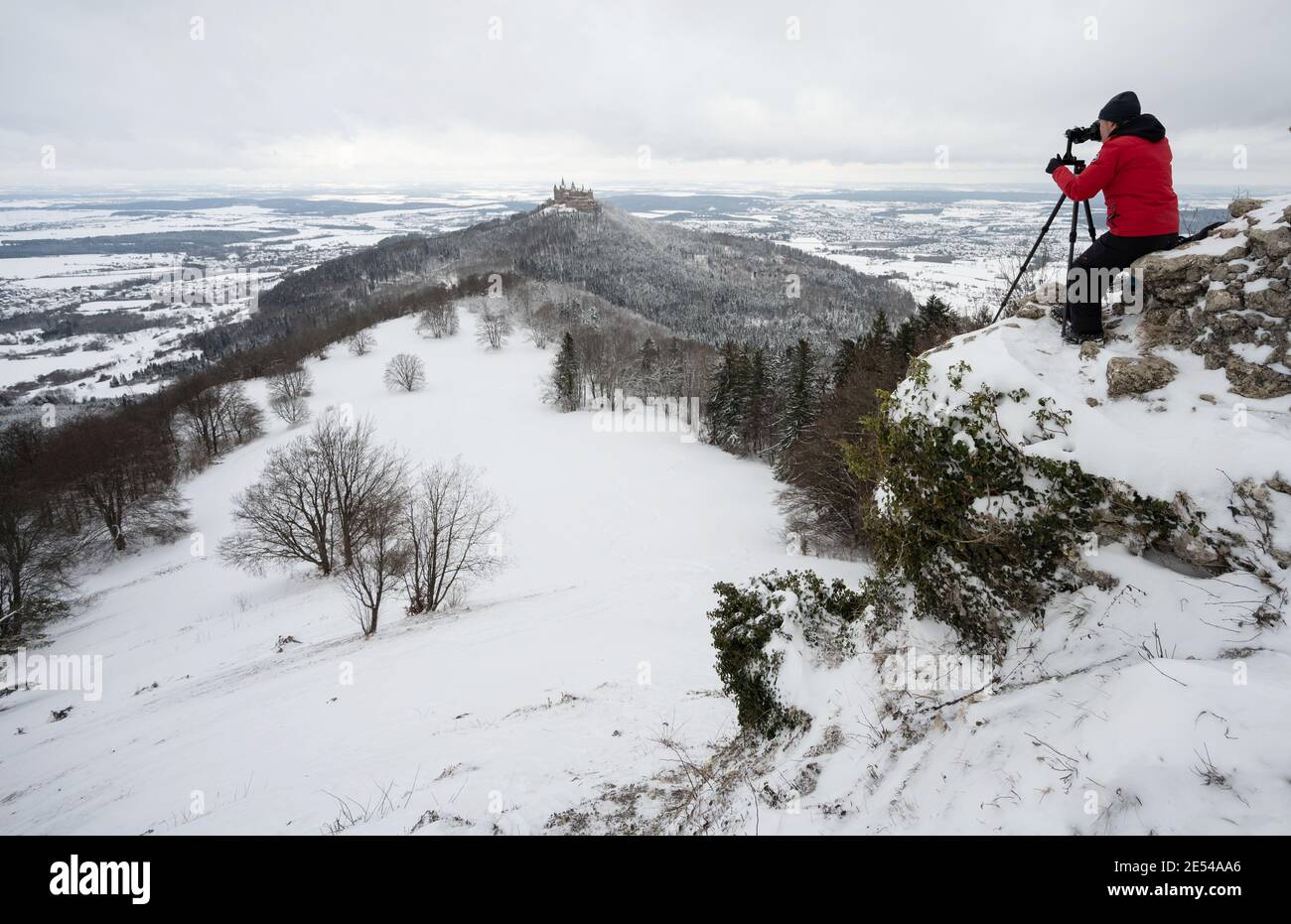 Albstadt, Germany. 26th Jan, 2021. A man photographs the snowcovered