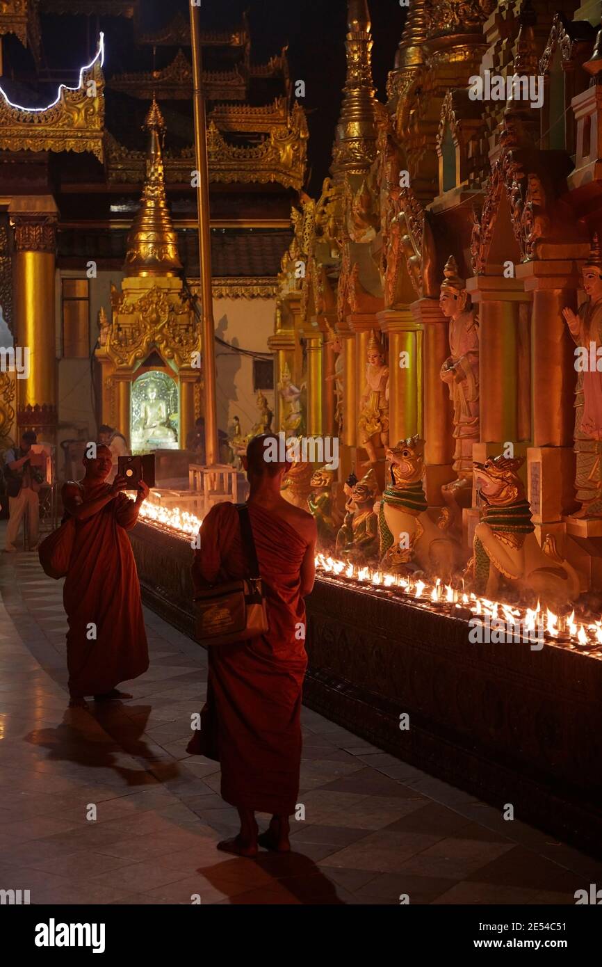 Two Buddhist Monks taking a picture with a tablet at the Shwedagon Pagoda, Yangon, Myanmar. Stock Photo