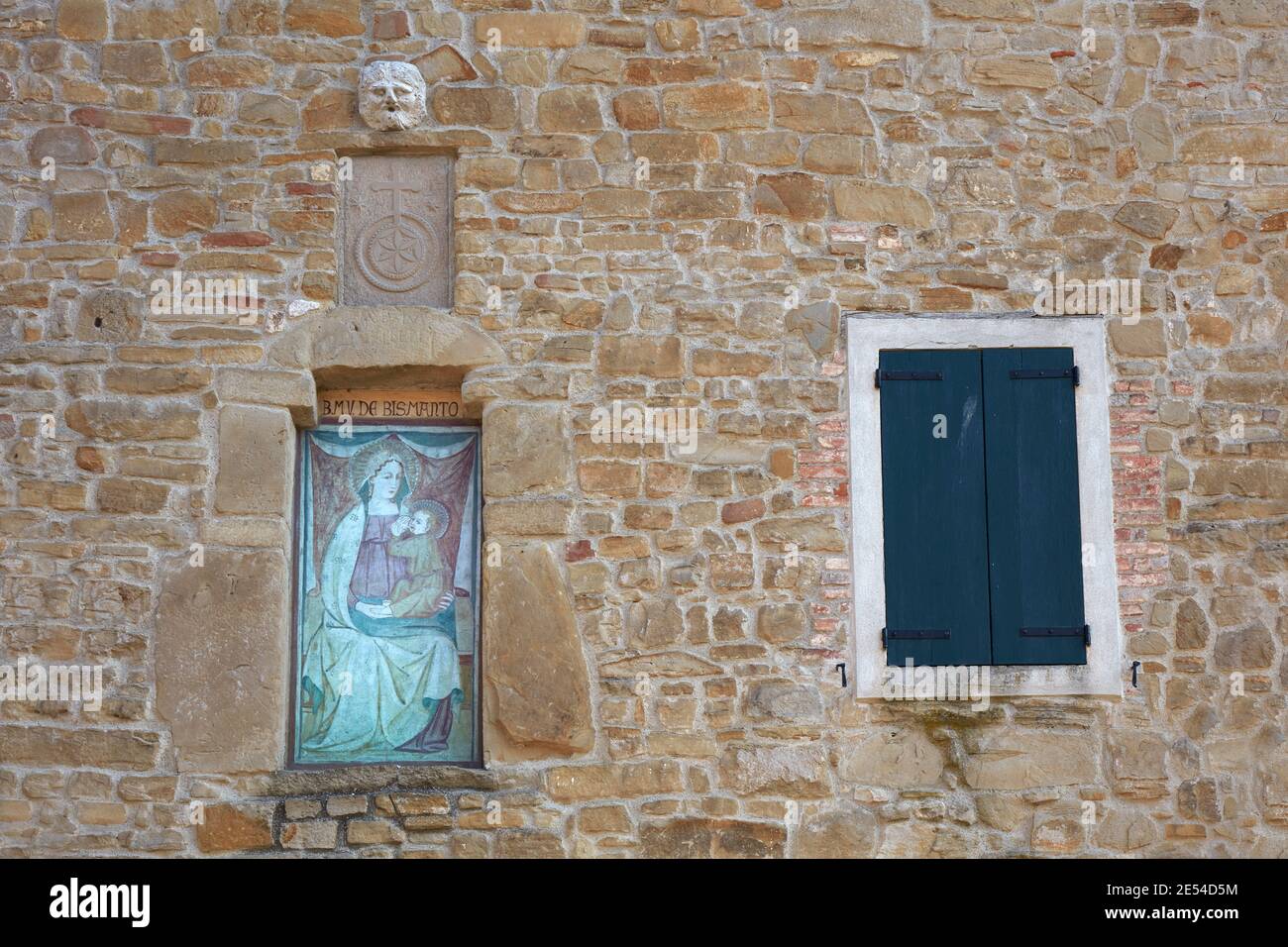 An ancient painting, a religious icon of the 'Madonna of Bismantova' on the wall of a traditional stone house. Casina, Emilia Romagna, Italy. Stock Photo