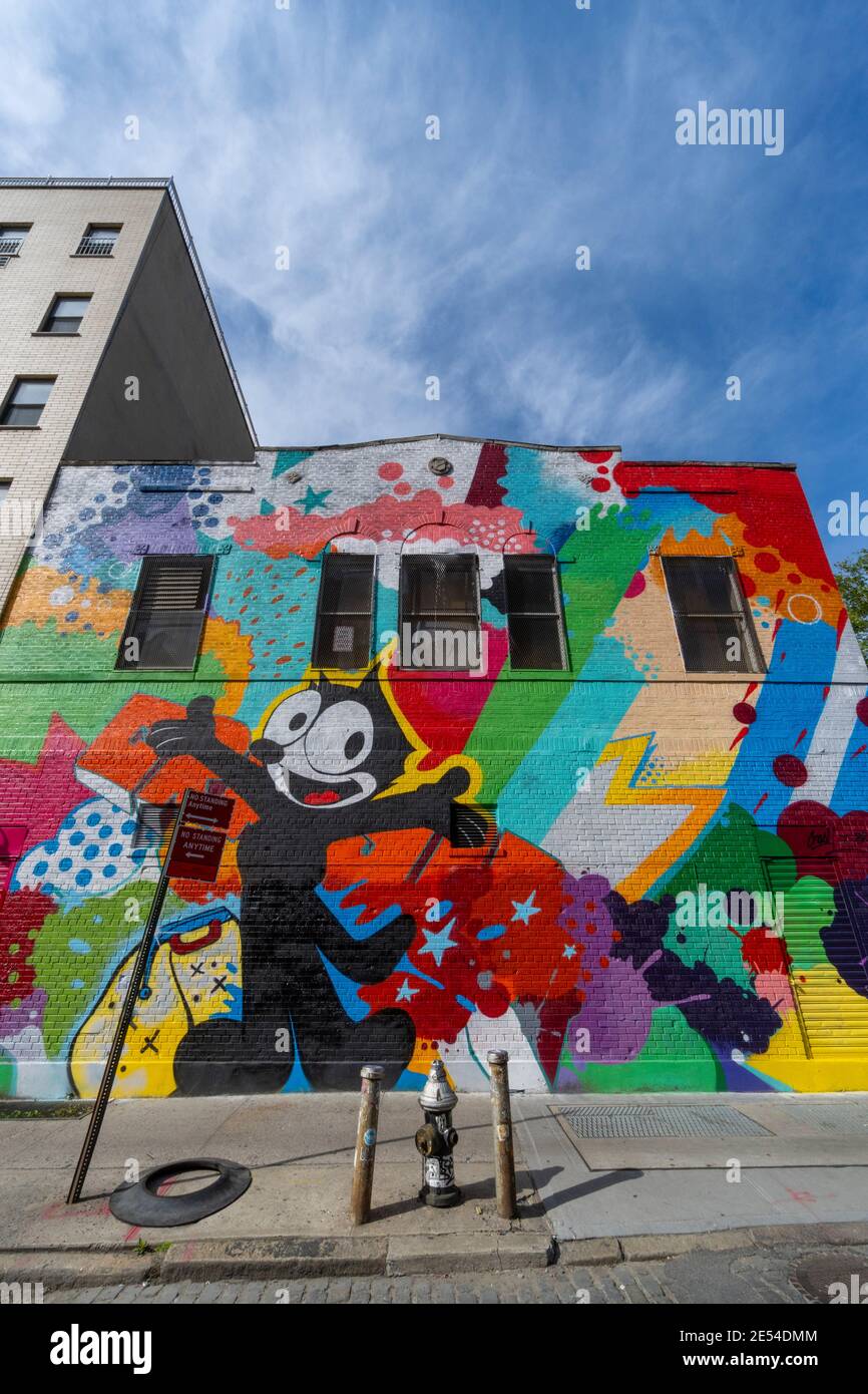 Artist creates mural on the building wall in Lower East Side NYC. Stock Photo