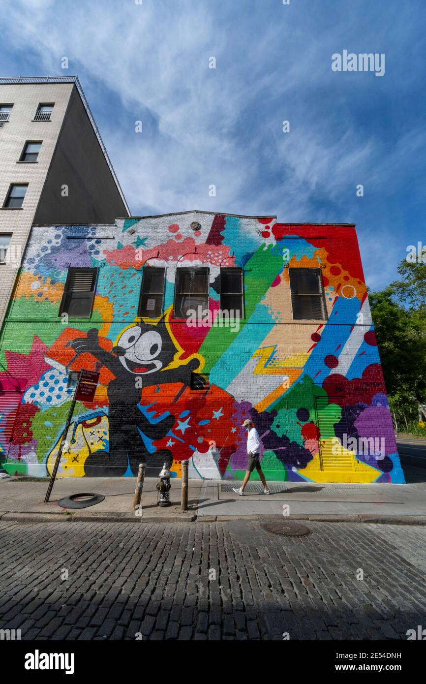 Artist creates mural on the building wall in Lower East Side NYC. Stock Photo