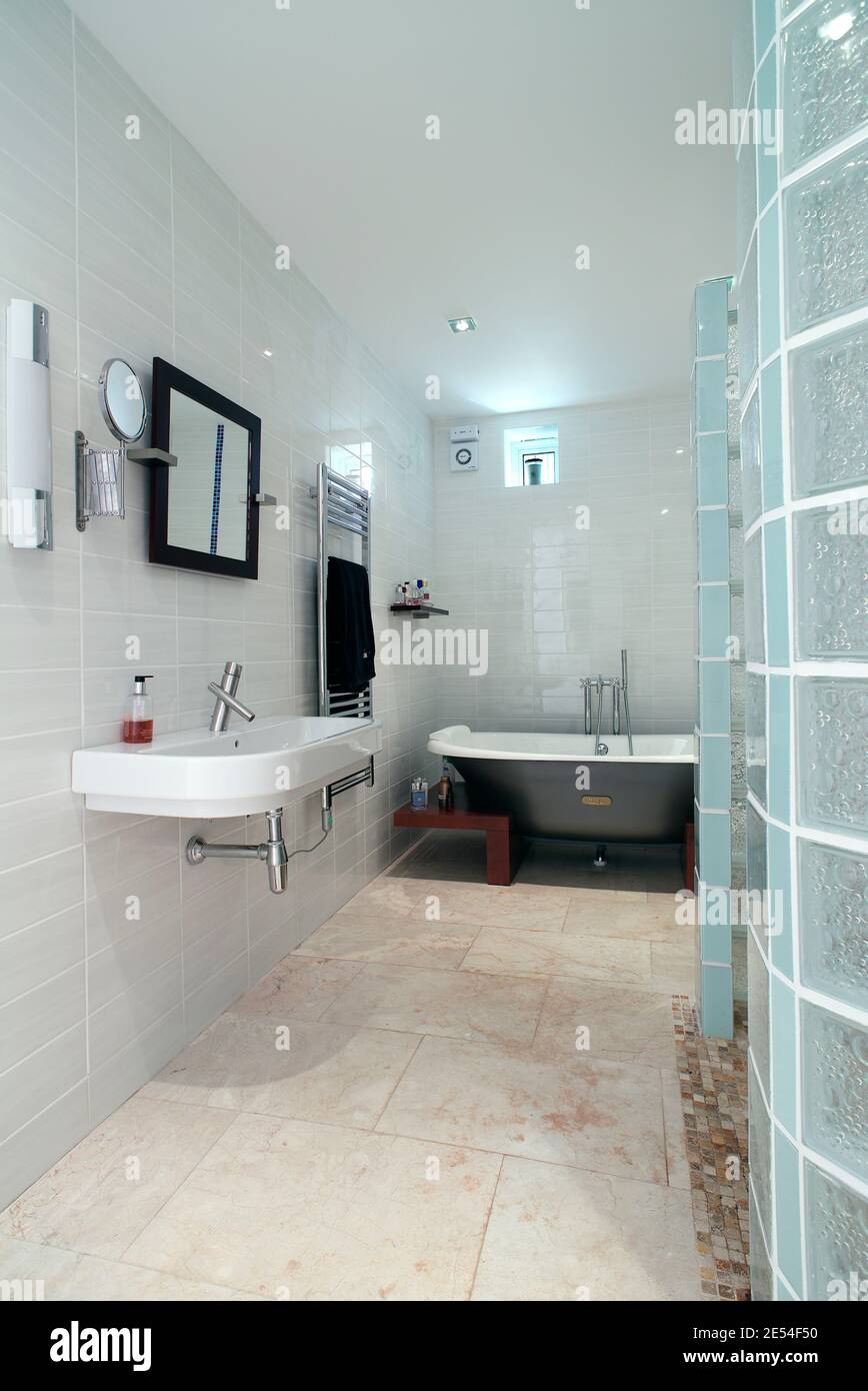 Master bedroom en suite bathroom. Looking past the glass brick shower to the bath. Architect