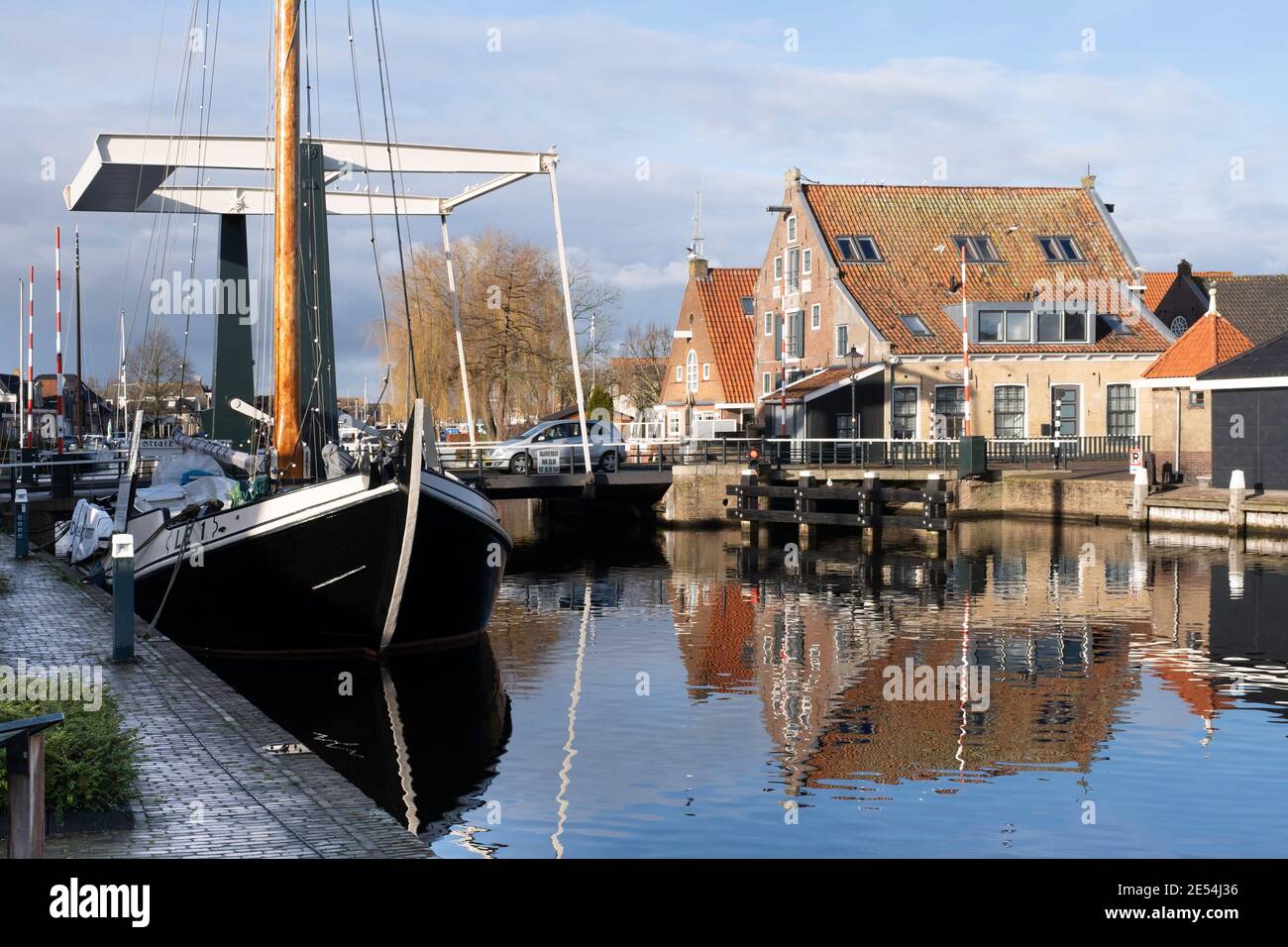 Cityscape of Lemmer, the Netherlands, with Flevobrug and a large sailing yacht on the left and a historic warehouse on the Zijlroede on the right Stock Photo