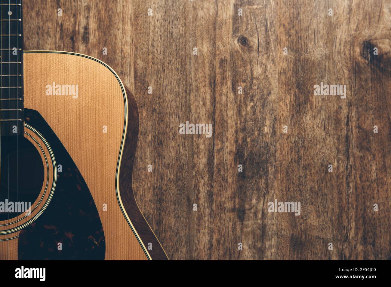 A guitar and a bible on a wooden background Stock Photo