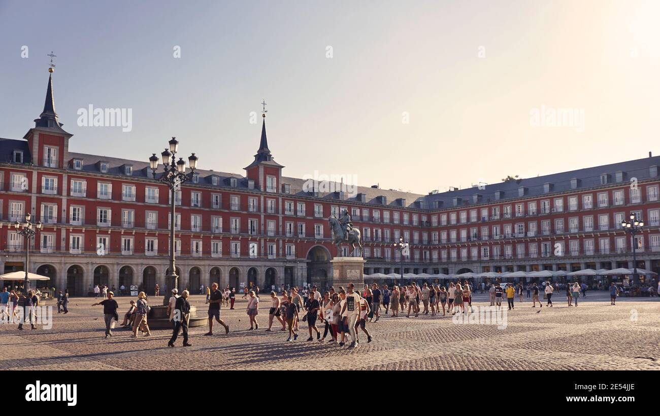 people walking the Plaza Mayor in Madrid Spain, one of the most famous squares in the city. Stock Photo