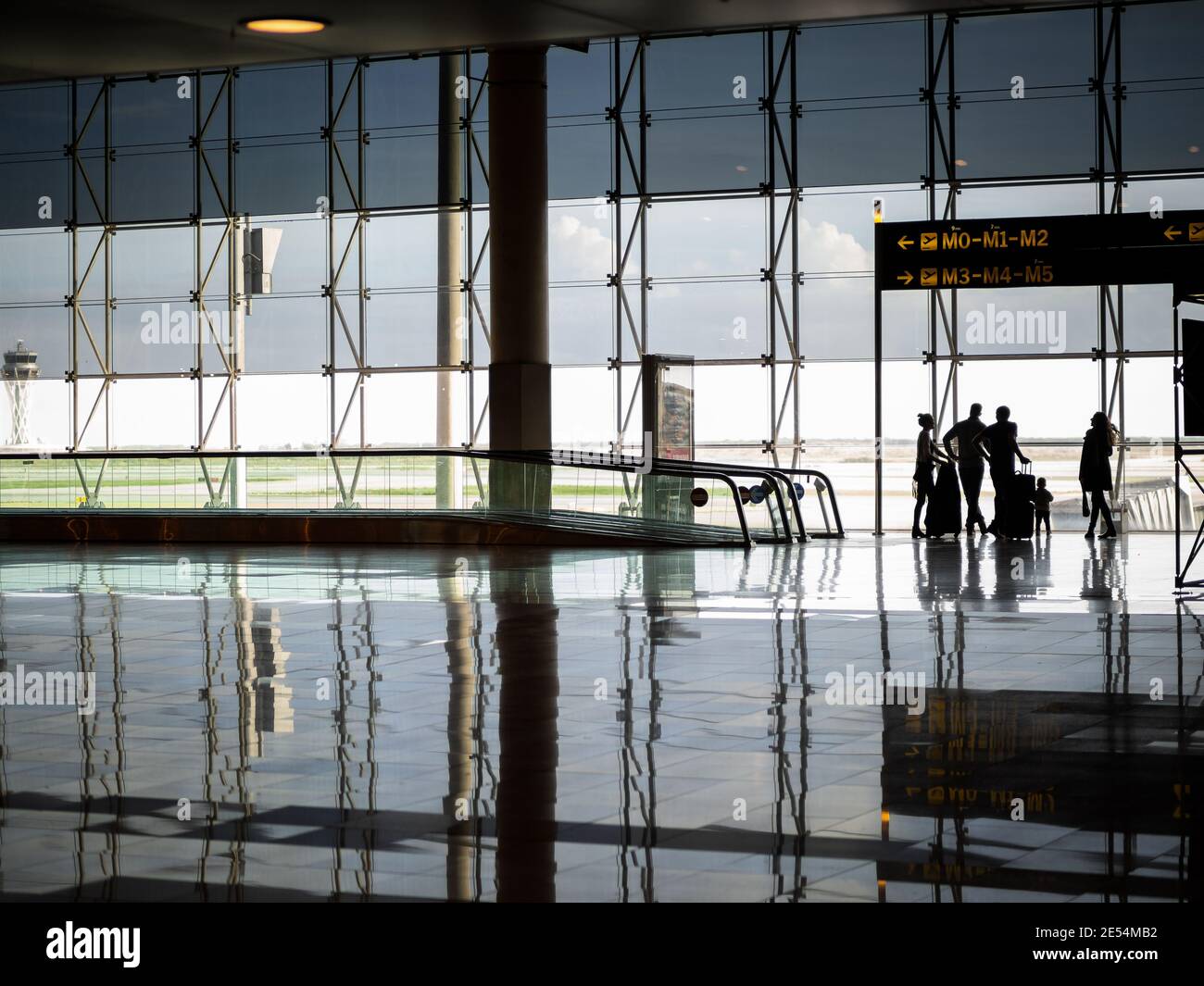 International airport in lockdown during Covid 19 pandemic waiting terminal for last aeroplane flight out of city centre runway home family silhouette Stock Photo