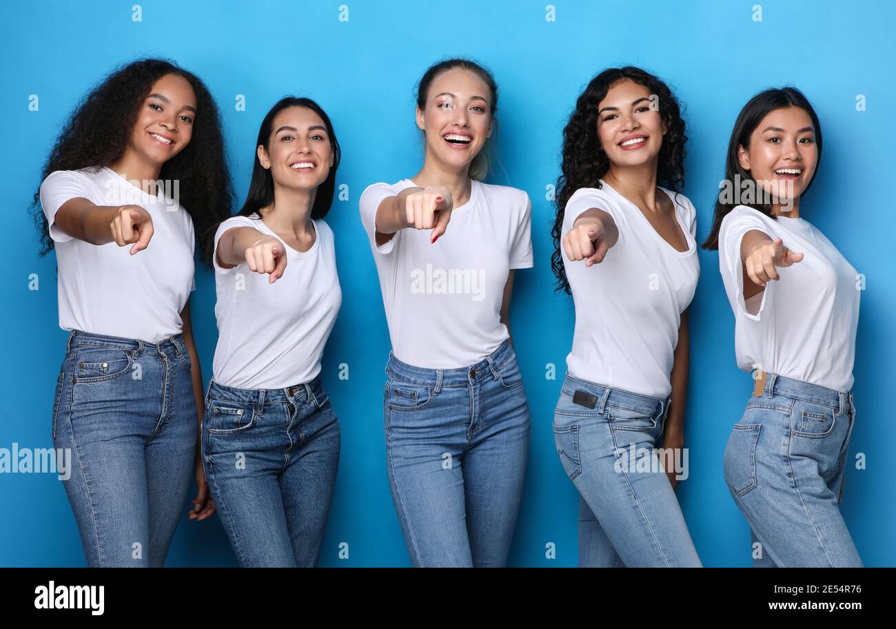 Group Of Multicultural Ladies Pointing Fingers At Camera, Blue Background Stock Photo