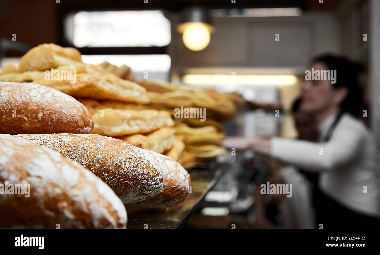 Interior of a bakery with saleswoman Stock Photo