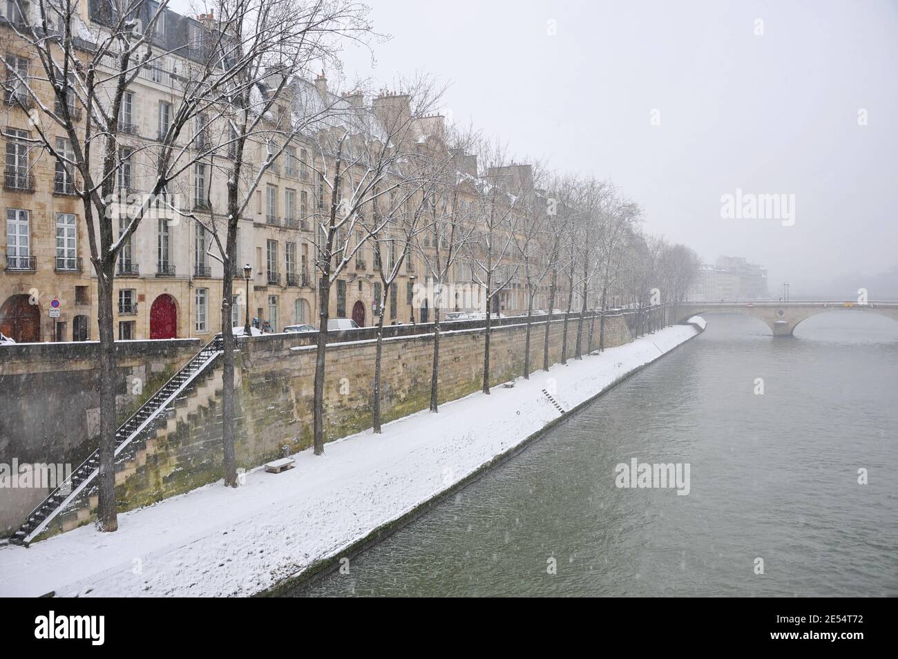 Winter in Paris, France. Parisian embankment covered with snow Stock Photo