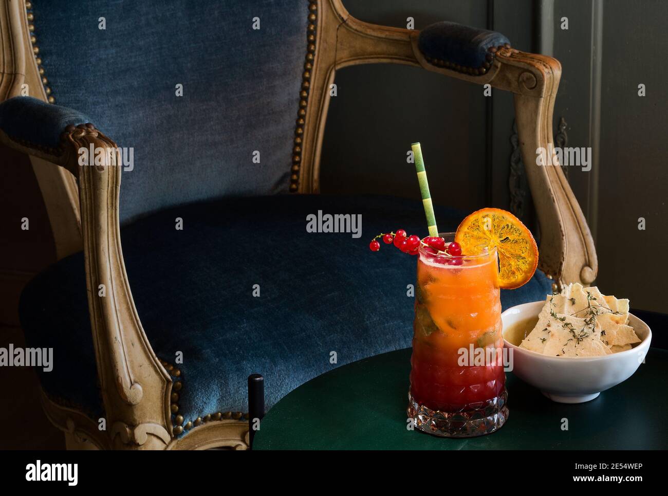 Cocktail juice with blue velvet chair Stock Photo