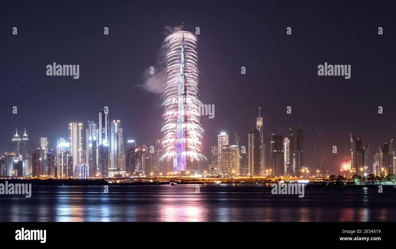 VIEW OF THE SPECTACULAR FIREWORKS  AT THE BURJ KHALIFA ILLUMINATED WITH THE UAE FLAG COLORS DURING THE NEW YEAR 2021 CELEBRATION IN CREEK HARBOUR Stock Photo