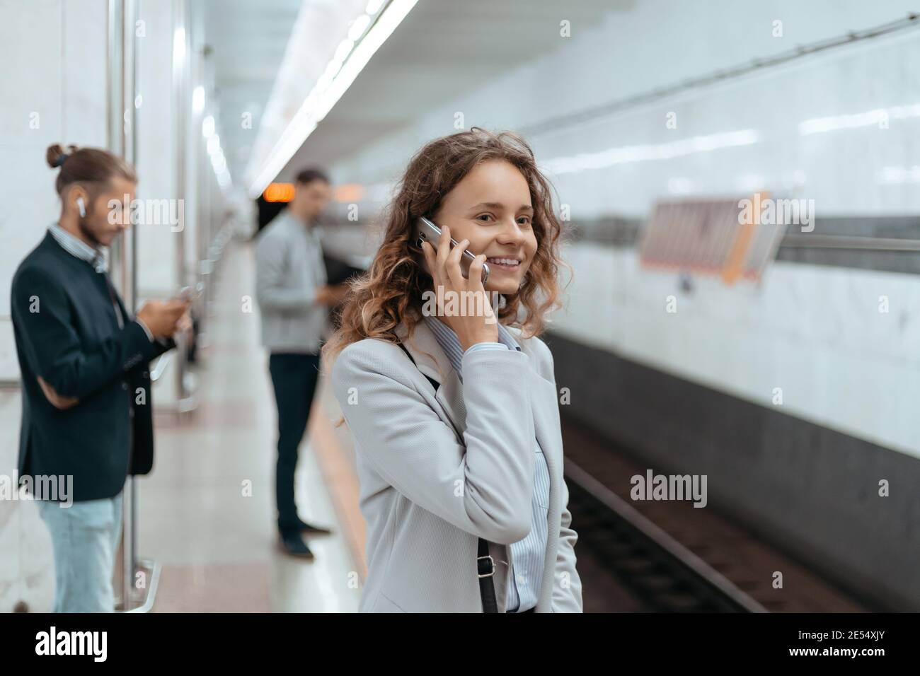 various passengers standing on the subway platform Stock Photo - Alamy