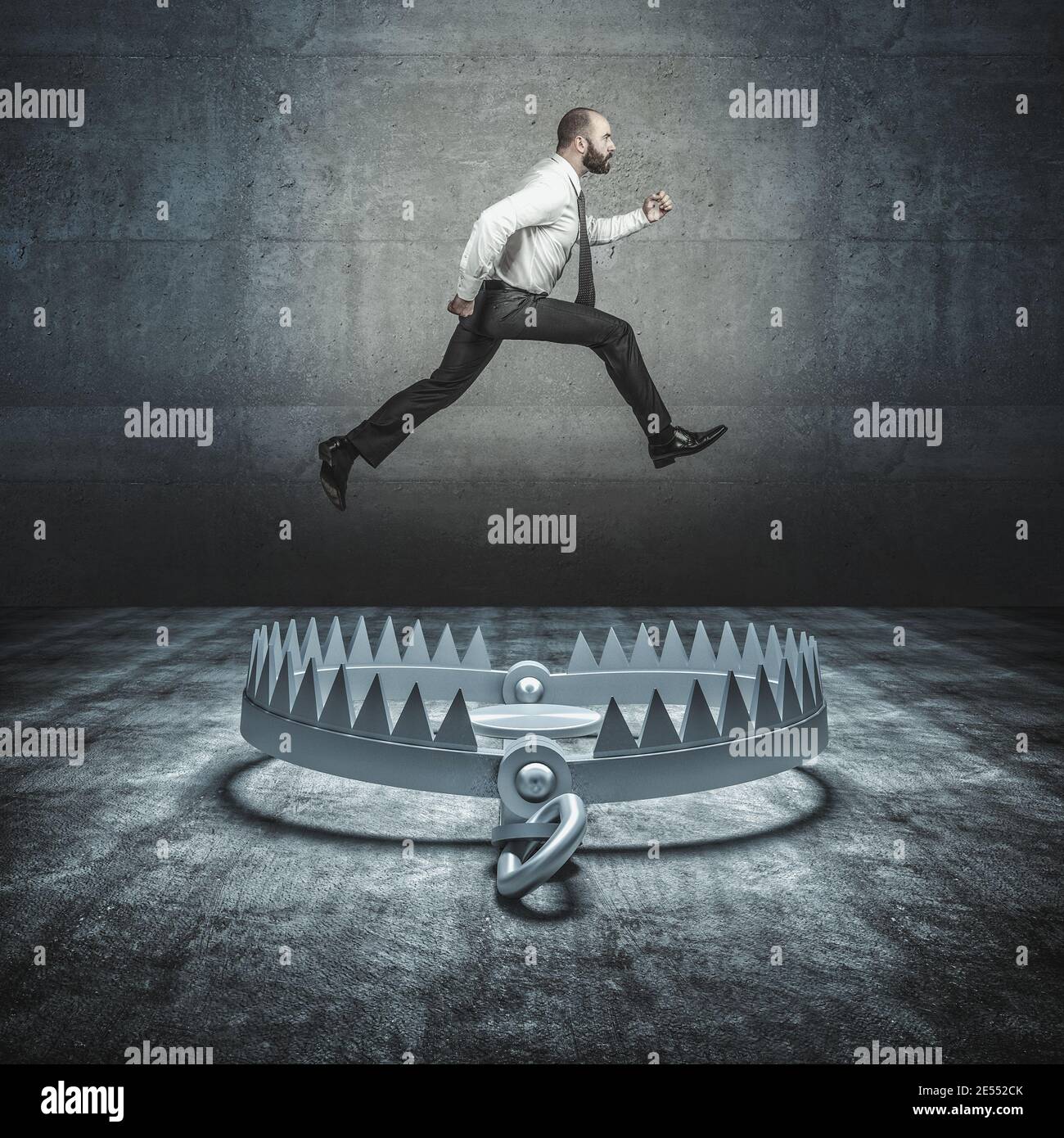 self-confident businessman jumps a big bear trap. concept of overcoming problems and adversity. Stock Photo