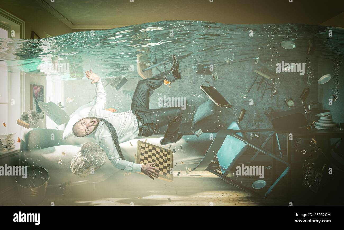 man in trouble in a flooded room of his home. concept of domestic problems. Stock Photo