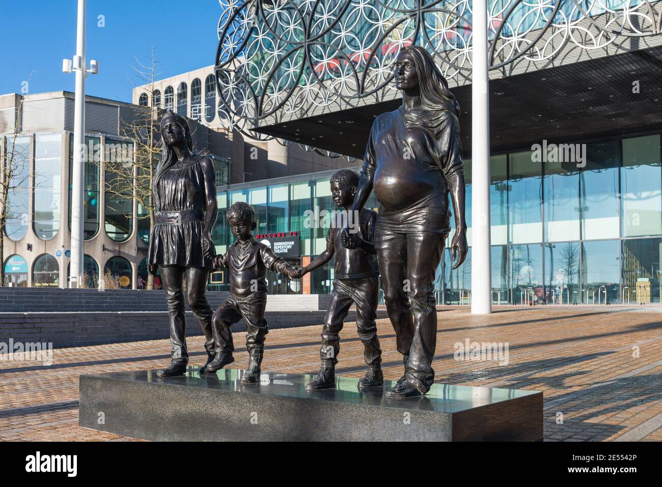 A Real Birmingham Family statue by Gillian Wearing stands in front of the Library of Birmingham in Centenary Square, Birmingham Stock Photo
